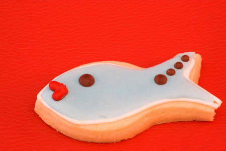 fish shpaed cookie  over  redの写真素材