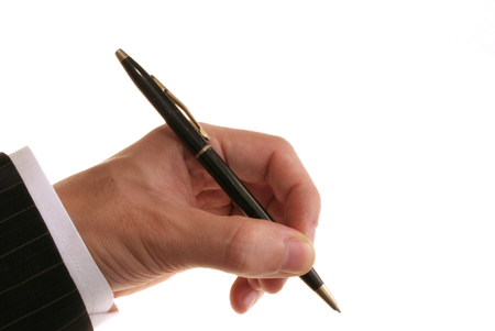 male in suit holding a ball point penの写真素材