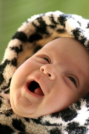 image of a happy smiling baby in a fancy dress with hood 