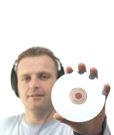 young man holding a compact disc  fosus on the compact discの写真素材