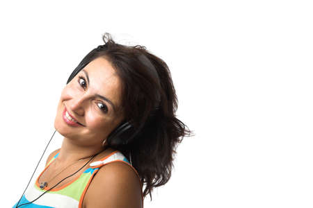 young woman  listenening to the music on earphones