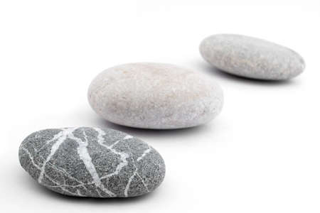 three pebbles placed on white background  shallow  depth of fieldの写真素材