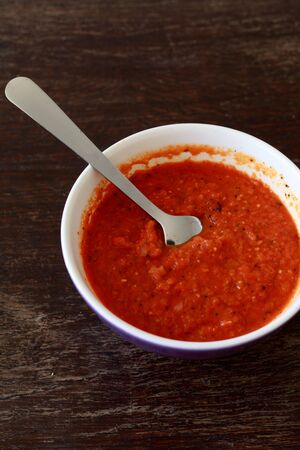 tomato sauce in a bowl placed on wooden tableの写真素材