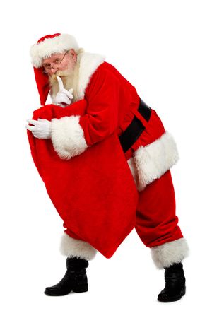 father christmas carrying his sack as he tip toesの写真素材