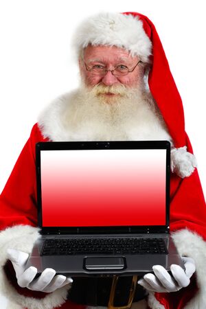 father christmas holding a laptop.Clipping path included for the lcd screenの写真素材
