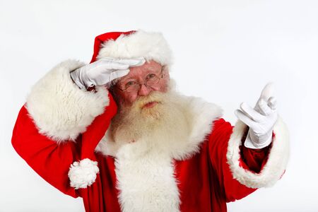 father christmas tryimng to something. studio shot on plain backgroundの写真素材