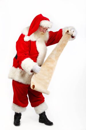 father christmas checking his list studio shot on plain backgroundの写真素材