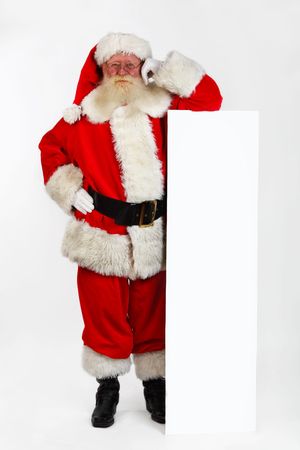 father christmas leaning on a notice boardの写真素材