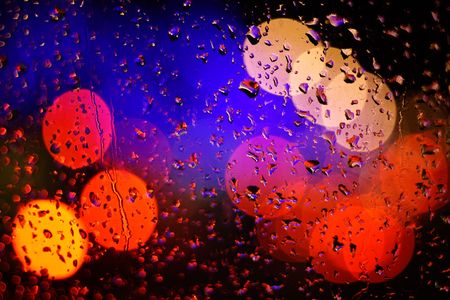 rain drops on window with blurry backgroundの写真素材