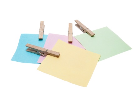 reminder note on color clothes pins on white background 