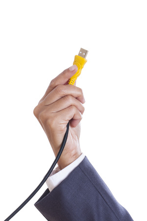 Businessman hand holding USB cable  with using path の写真素材