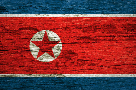 North Korea flag painted on old wood plank background の写真素材