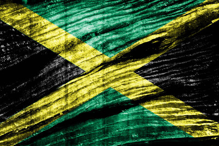 Jamaica Flag painted on old wood background の写真素材