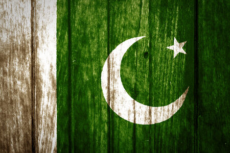 Pakistan flag on old wood background の写真素材