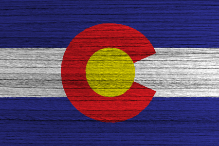 Flag of the state of Colorado painted on wood background の写真素材
