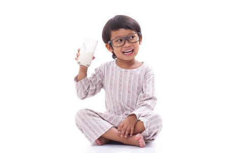Cute boy drink milk isolated on white の写真素材
