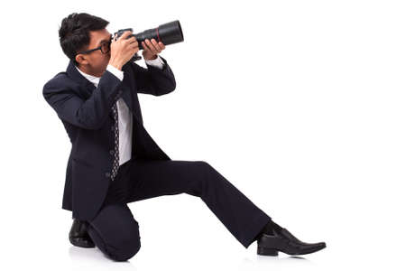 Businessman taking a photo on white backgroundの写真素材