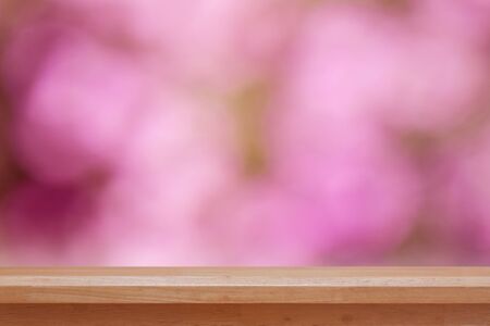 Wood table top on pink bokeh abstract background, can be used for montage or display your products
