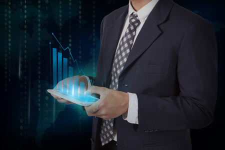 Businessman hand touch screen growth chart on a tablet, communication concept.の写真素材
