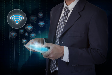 Businessman hand touch screen wifi symbol on a tablet.の写真素材