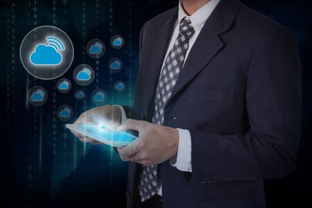 Businessman hand touch screen WiFi cloud icon on a tablet.の写真素材