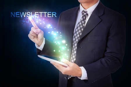 Businessman holding tablet with pressing newsletter. internet and networking conceptの写真素材