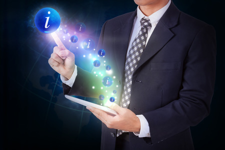 Businessman holding tablet with pressing info icon button. internet and technology conceptの写真素材