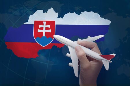 hand holding airplane with map of Slovakia.の写真素材