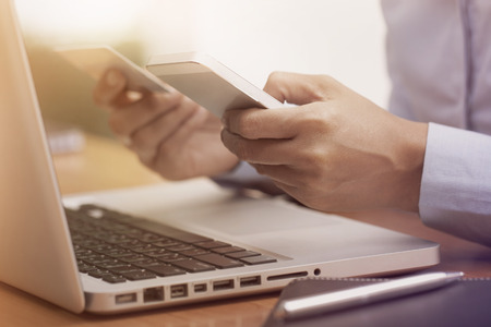 Business woman hands holding credit card and using cell smart phone for online shopping. の写真素材
