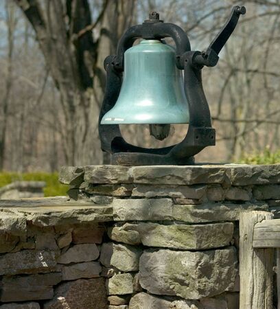 bell on stone wallの写真素材