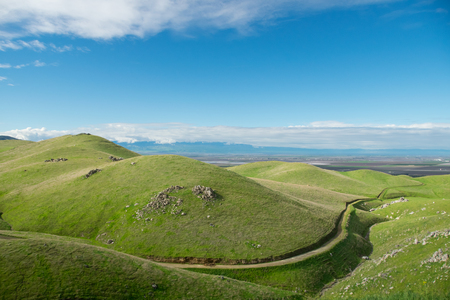 Green hills with blue skyの写真素材