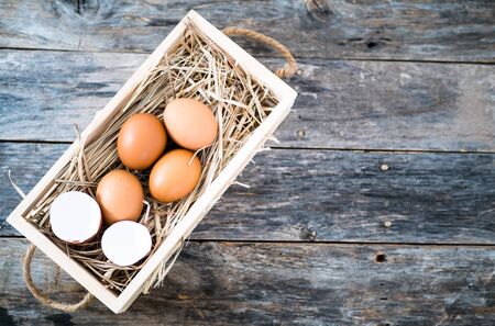 Chicken eggs in a wooden box in a high angleの写真素材