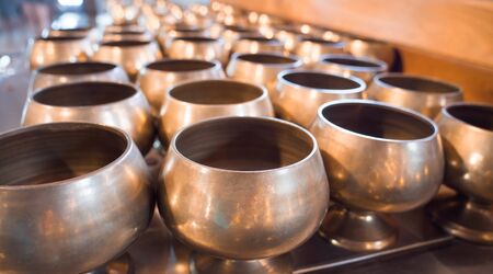 Monk is a brass container used to put coins at the temple.の写真素材