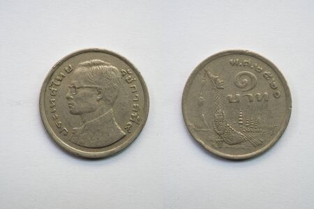 Old Thai coin on white background, king and Garuda, 1 baht, B.E. 2520の写真素材