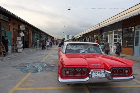 BANGKOK, THAILAND - SEPTEMBER 17, 2016: Old vintage red car at Night market, Srinakarin road, that name is train market. This market is open every Wednesday to sunday.のeditorial素材