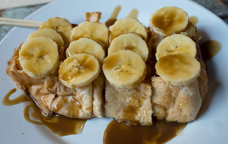 Caramel banana toast on white dishの写真素材
