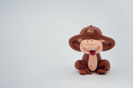 brown monkey doll close eyes isolate white backgroundの写真素材