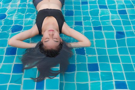 Woman enjoy and relaxing in swimming pool and copy space for textの写真素材
