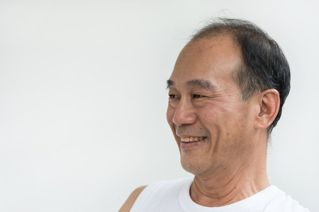 portrait of smile old man asia wear white shirt on white backgroundの写真素材