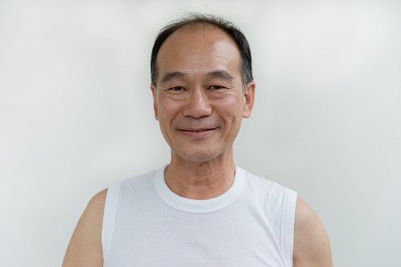 portrait of old man asia wear white shirt on white backgroundの写真素材