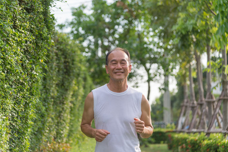 old man exercise by jogging at the park, health conceptの写真素材