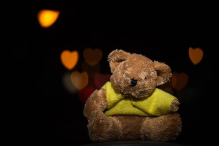 teddy bear with heart bokeh on black background, for Valentine's Dayの写真素材