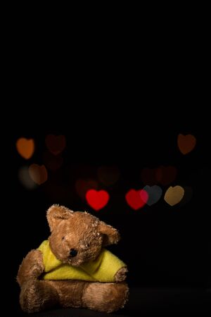 teddy bear with heart bokeh on black background, for Valentine's Dayの写真素材