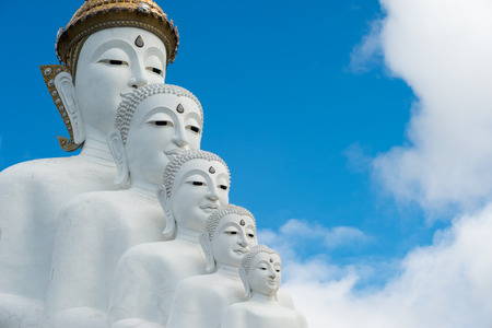 Phetchabun Province, Thailand - September 3, 2017: Face of Five White Buddha statues sit at Wat Pha Sorn Kaew Temple or Wat Phra Thart Pha Kaew Temple in Khao Kho, Thailand. The Temple is set on an 830m peak.のeditorial素材
