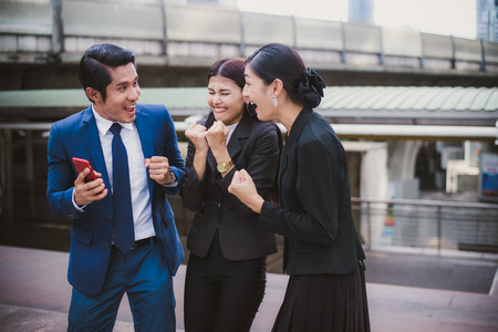 Asian businessman and businesswoman smile and cheerful for successful in mission. concept of winner and compettition.の写真素材