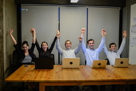 business man and business woman show hand up demonstrate to business successの写真素材