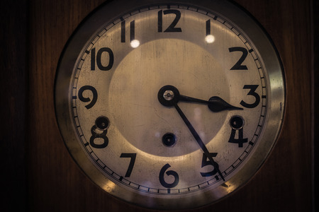 old yellow vintage clock on wooden backgroundの写真素材