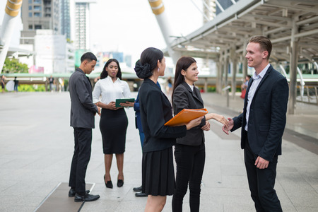 Group of business people standing in the city and discussing ideas for business future. multi culture of business people, African, Caucasian and Asian.の写真素材