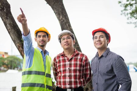 engineer and construction team wearing safety helmet and working at construction site. engineer and...