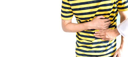 doctor touches the patient's stomach. who are having a stomachache pain. concept of health, Illness and medical treatment. white copy spaceの写真素材